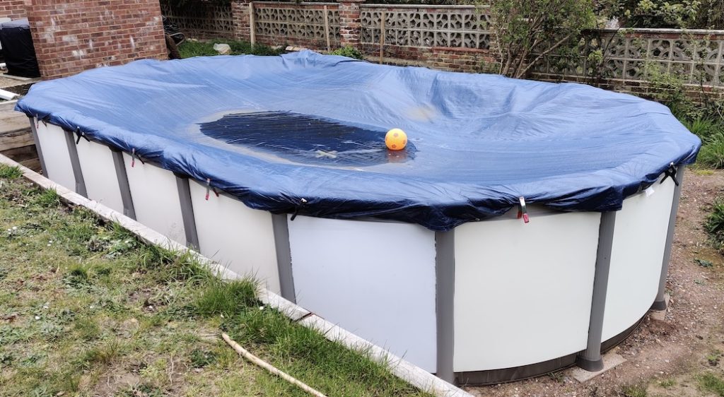 Oval pool with winter cover on.